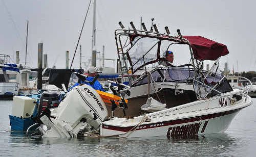 A man and his dog were rescued from his boat on Thursday night after it was smashed up against a sand bar on the Pelican Banks. The boat was towed back yesterday. A man and his dog were rescued from his boat on Thursday night after it was smashed up against a sand bar on the Pelican Banks. The boat was towed back yesterday.